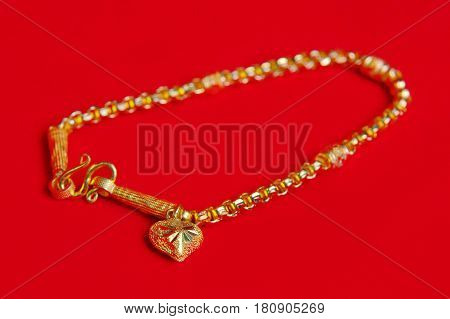 Gold Necklace 96.5 Percent Thai Gold Grade With Gold Heart Pendant Isolated On Red Flannel Cloth Bac