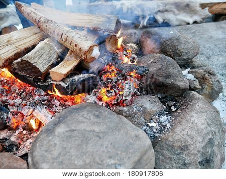 Burning woods to fuel the fire in winter.