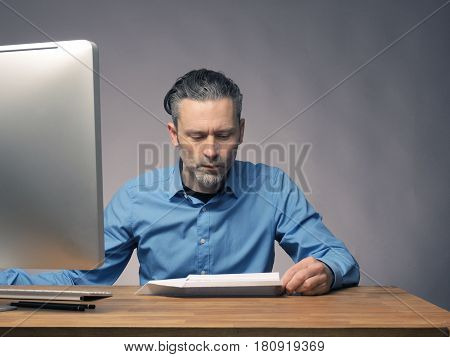 Handsome businessman with a paper plane start up or upswing concept
