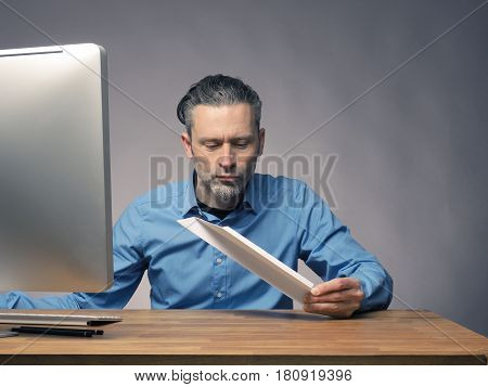 Handsome businessman with a paper plane start up or upswing concept
