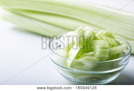 Fresh organic celery in a  bowl on a white background, selective focus