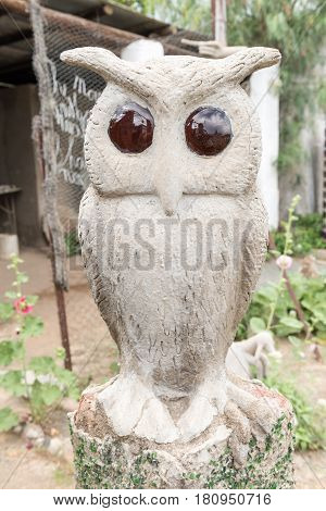 NIEU BETHESDA SOUTH AFRICA - MARCH 21 2017: A concrete and glass owl sculpture at the Owl House in Nieu-Bethesda an historic village in the Eastern Cape Province