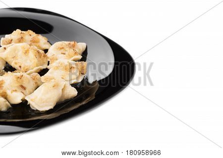 Fresh Dumplings On A Black Plate Seasoned With Crispy Onions. Ukraine