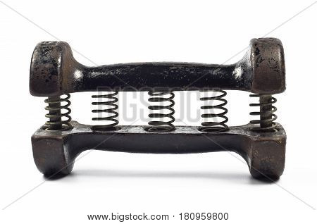 Old cast iron dumbbell carpal expander with springs on white background