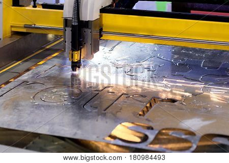 The CNC laser cut machine while cutting the sheet metal with the sparking light.The hi-precision sheet cutting process by laser cut
