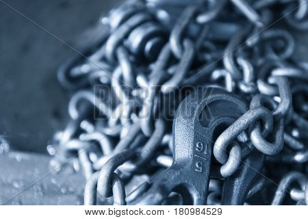 The hook on the pile of chain in light blue scene