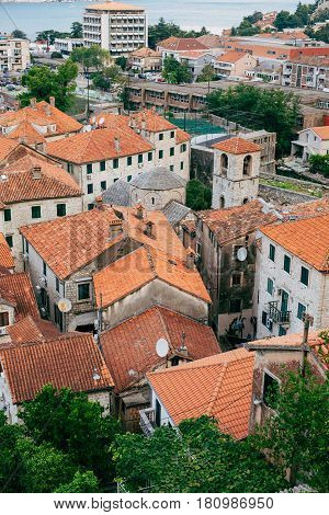 The Old Town of Kotor. The orange-tiled rooftops of the city. Shooting from the observation platform on the wall of the city. Montenegro