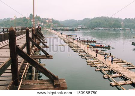 Kanchanaburi Thailand - December 09 2013: Temporary Bridge beside Saphan Mon (Mon Bridge) due to heavy flood damaged the old wooden bridge across Song Karia River in morning time in Sangklaburi District