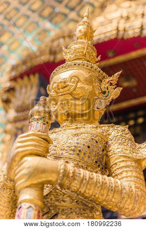 Closeup beautiful Golden Giant in Wat Phra Kaew or the Temple of the Emerald Buddha or Wat Phra Sri Rattana Satsadaram Bangkok Thailand.