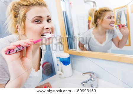 Woman Brushing Cleaning Teeth In Bathroom