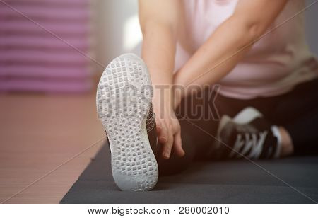 Eldery Woman Is Engaged In Stretching On A Sports Rug. Healthy Lifestyle And Healthy Legs Concept