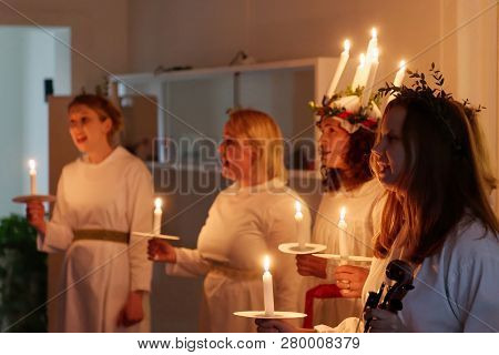 Stockholm, Sweden - Dec 13, 2018: Lucia Parade With Singing Girls In White Dresses Holding Candles. 