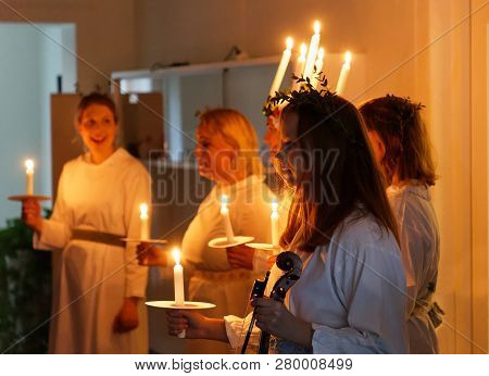 Stockholm, Sweden - Dec 13, 2018: Lucia Parade With Singing Girls In White Dresses Holding Candles. 