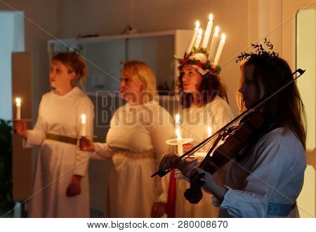 Stockholm, Sweden - Dec 13, 2018: Lucia Parade With Singing Girls In White Dresses Holding Candles. 