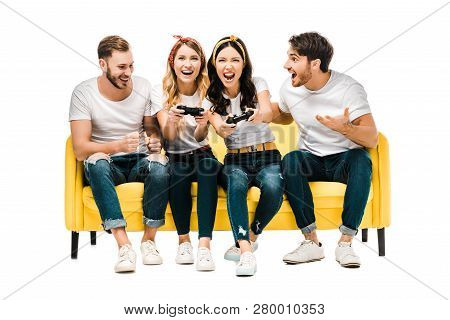Young Men Looking At Excited Attractive Women Playing With Joysticks Isolated On White