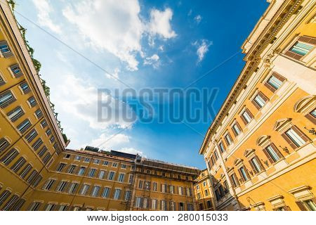 Montecitorio Square Under A Blue Sky With Clouds In Rome, Italy