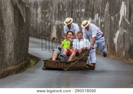 FUNCHAL, MADEIRA - SEPTEMBER 19: Traditional downhill sledge trip on September 19, 2016 in Madeira, Portugal.