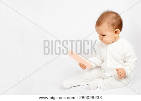 Baby Holding A Mobile Phone Isolated On White Background