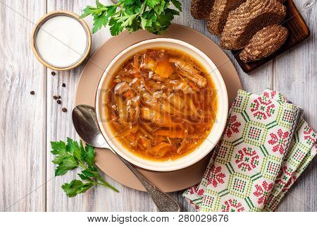 Traditional Russian Sauerkraut Soup Shchi In Bowl On Rustic Wooden Background