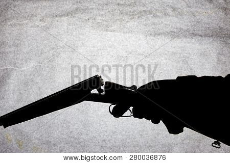 Classic Double-barrell Smooth-bore Hunting Rifle On Man Hand Isolated On Light Stone Background