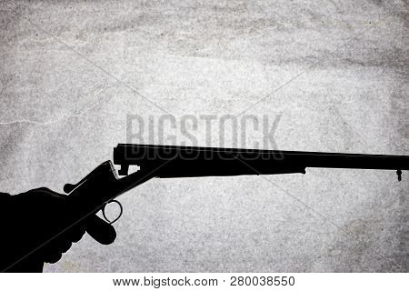 Classic Double-barrell Smooth-bore Hunting Rifle On Man Hand Isolated On Light Stone Background