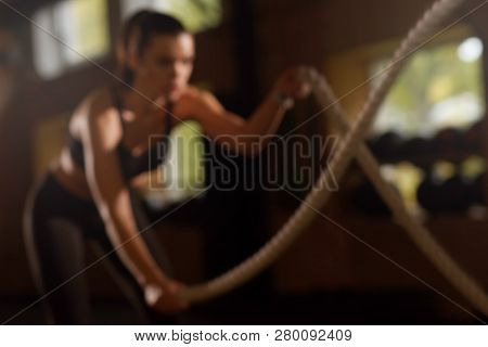 Fit, Sporty And Athletic Sportswoman Working In A Gym. Womantraining Using Ropes. Sports, Athletics,