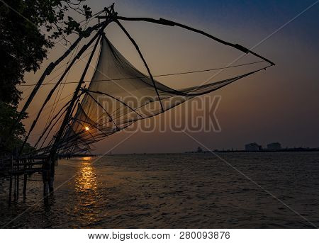 Fishing Nets Idle At Sunset In Kochin, India