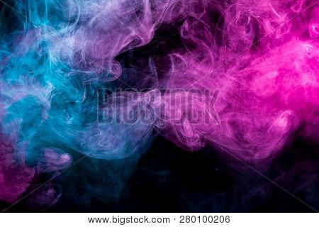 Thick Colorful Pink And Blue  Smoke  In The Form Of A Sky On A Black Isolated Background. Background