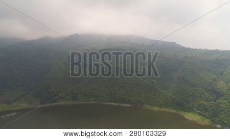Aerial View Lake Menjer In Fog And Clouds. Lake In Mountains With Green Rain Forest. Tropical Landsc