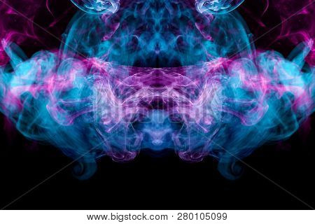 Thick Colorful Bkue And Pink Smoke  In The Form Of A Butterfly On A Black Isolated Background. Backg