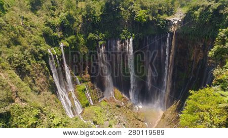 Beautiful Waterfall Coban Sewu In Tropical Forest, Java Indonesia. Aerial View Tumpak Sewu Waterfall