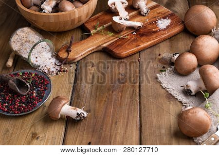 Champignon Mushrooms With Red Onions And Spices On A Wooden Background, Wooden Utensils. Rustic Styl