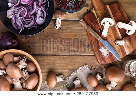Champignon Mushrooms With Red Onions And Spices On A Wooden Background, Wooden Utensils. Rustic Styl