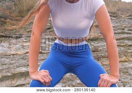 Flat Belly Girl During Diaphragmatic Breathing Exercises Bodyflex On The Rock Background. Belly Clos