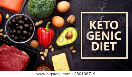 Photo of products for diet on black stone table .Ketogenic diet concept.