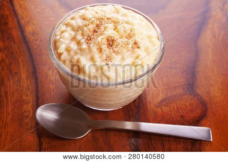 Rice Pudding Sprinkled With Nutmeg In An Individual Glass Bowl.