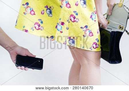 Sexual Harassment At Work. Man Taking A Photo With Mobile Phone Of Secretary's Butt