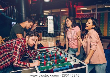 Happy Young Women Look At Men And Shrink. They Win Game. Guys Lost It. They Dissapointed. Young Peop