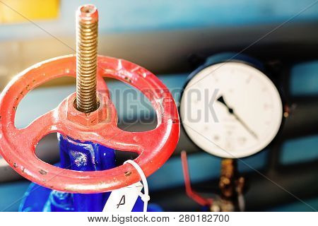 Red Gas Valve And Pressure Gauge With An Arrow On The Limit. Background For Gasification.