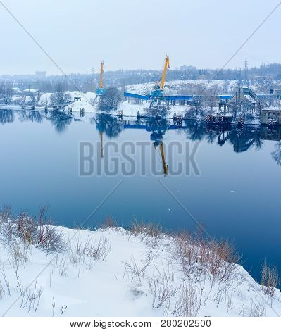 Snow-covered Cargo Berth For Loading Rubble On The River.