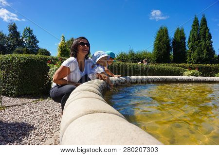 Dobrzyca, Poland - August 6, 2018: Woman And Two Young Boys By A Fountain In The Hortulus Park On A 