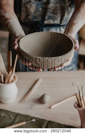 Pottery, Clay, Ceramics Art Concept - Closeup On Hands Of Young Master With The Large Plate From Fir
