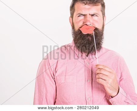 Man With Stylish Beard Holding Sensual Paper Lips. Bearded Man In Pink Shirt Frowning Isolated On Wh