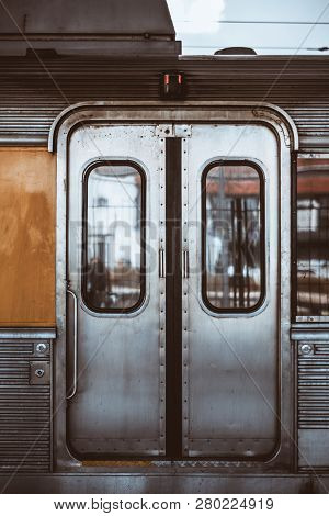 Vertical Shot Of The Metal Grungy Closed Automatic Doors Of A Chrome Carriage Trim Of A European Sub