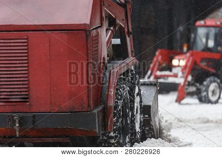 Two Red Snowblowers Clears Snow From The Street After A Big Snowstorm, Back View/ Snowy Winter, Snow