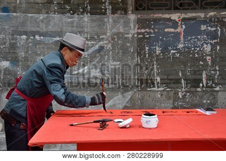 Foshan, China - Circa January 2019: An Old Man Writing Blessing Couplet At The Occasion Of Spring Fe