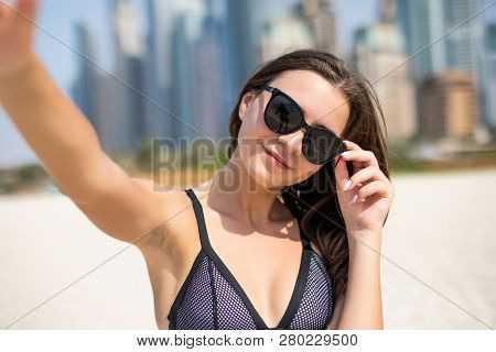 Pretty Young Woman In Swimsuit Taking Selfie On The Jbr Beach In Dubai. Pretty Young Female Tourist 