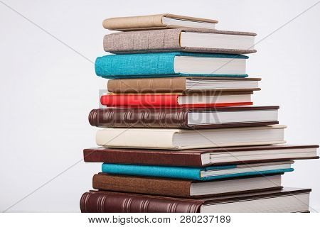 Multi-colored Albums Of Different Sizes And Textures On A White Background