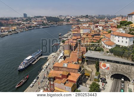 Porto, Portugal - June 21, 2017 - Drone View Of Porto With The Duoro River Boats Plying Their Trade