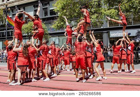 San Francisco, California, June 24, 2018:  Gay Pride Parade - Acrobats Perform Aerial Stunts While M